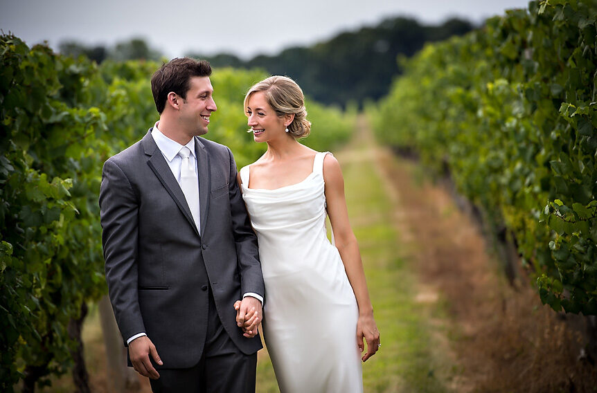 A bride and groom standing in a vineyard in New York, capturing the essence of a picturesque wedding in the heart of NYC.