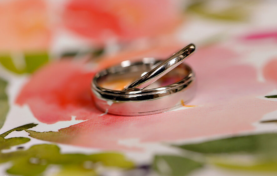 A pair of wedding rings on a watercolor background in NYC.