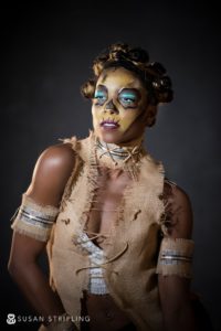 A woman in costume and makeup posing for a wedding photo in NYC.