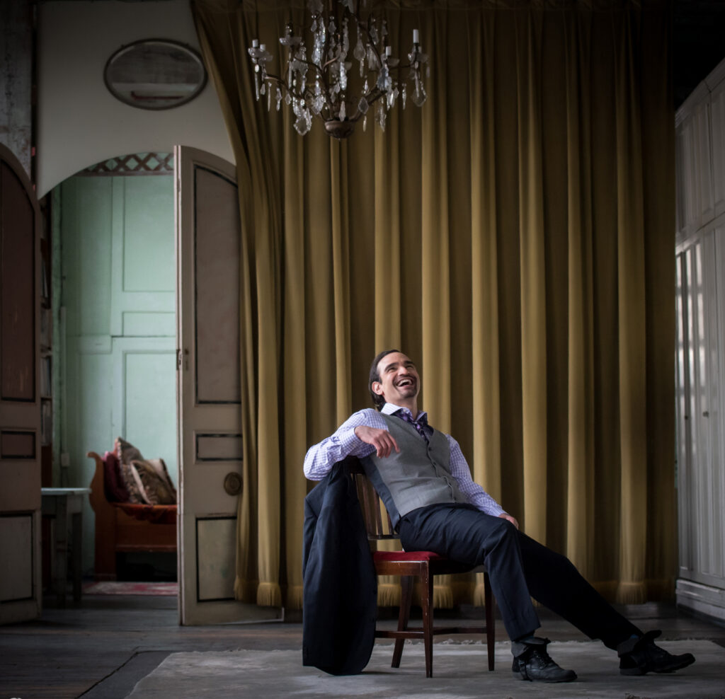 A man sitting on a chair in a New York City room.