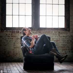 A man sitting in a chair in an empty room in New York City.