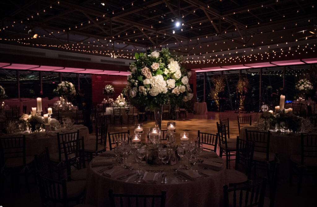 A romantic winter wedding reception set up with candles and flowers at the Kimmel Center.