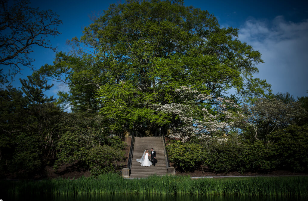 A bride and groom exchanging vows in the breathtaking gardens of Old Westbury.