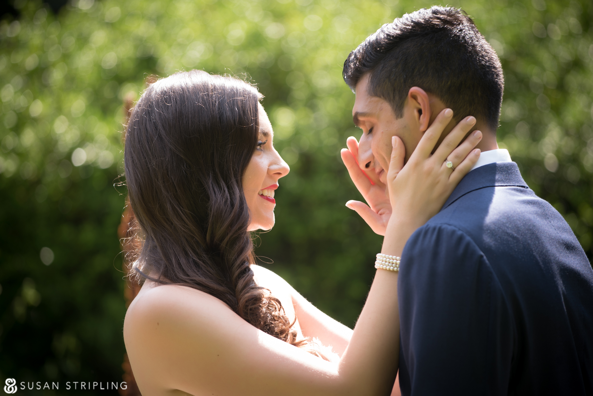 A summer wedding at the Brooklyn Botanic Garden, with the bride and groom gazes lovingly at each other.