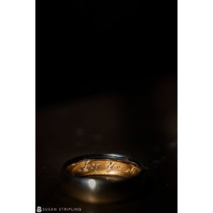A wedding ring with the word love written on it, perfect for a romantic ceremony amidst the enchanting beauty of Rock Creek Gardens.