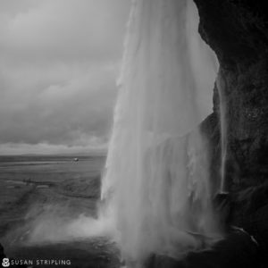 A black and white photo of a waterfall in Iceland, known for its appearances in Game of Thrones.