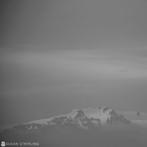 A black and white photo of a snow covered mountain, potentially reminiscent of Game of Thrones' scenic locations.