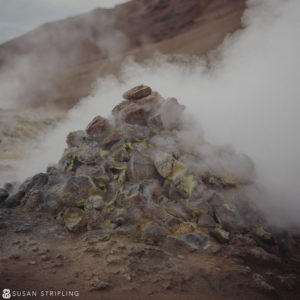A pile of rocks with steam coming out of them reminiscent of a mysterious Game of Thrones location.