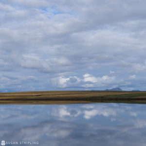 A Game of Thrones Location photo captures the ethereal beauty of a cloudy sky reflecting in a body of water.