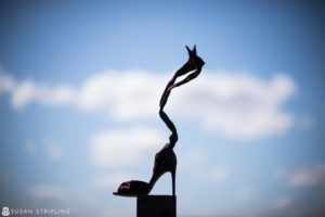 A stunning sculpture of a high heel shoe on top of a pole, perfect for a Fall Wedding at the Brooklyn Botanic Garden.