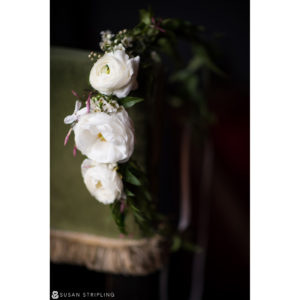 A bouquet of white flowers on a green chair during a wedding at the Gramercy Park Hotel.