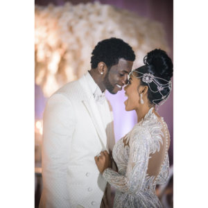 Gucci Mane and Keyshia Ka'oir are smiling at each other at their wedding reception in these pictures.