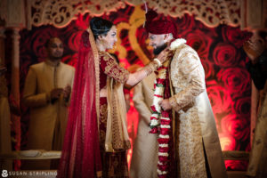 A New Jersey Indian bride and groom sharing a kiss during their wedding ceremony.