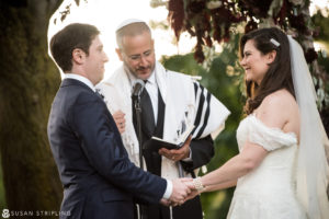 A bride and groom exchange vows during a Fall wedding ceremony at the Brooklyn Botanic Garden.