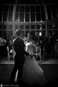 A bride and groom sharing their first dance at night during a Fall Wedding at the Brooklyn Botanic Garden.