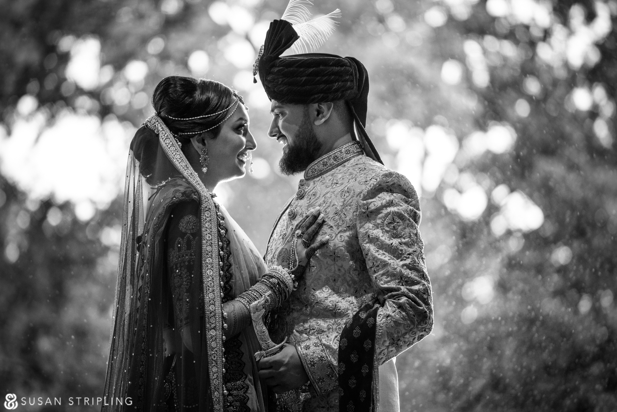 A black and white photo of a bride and groom in the rain at a New Jersey Indian wedding.