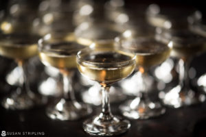 Keywords: wedding, glasses

Modified description: A set of wine glasses arranged elegantly on a table at a wedding.