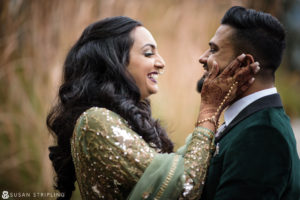 A bride and groom smiling at each other during their New Jersey Indian wedding.