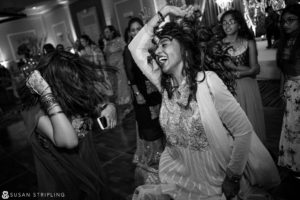 A woman dancing on the dance floor at a New Jersey Indian wedding.