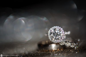 A wedding ring and engagement ring sitting on a table at Current Chelsea Piers.