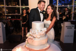 A bride and groom cutting their wedding cake at Chelsea Piers.