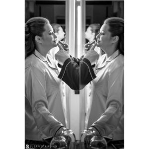 A Cescaphe Philadelphia bride getting ready in front of a mirror.