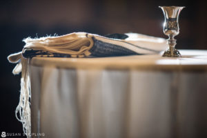 A Jewish table with a candle and a towel on it, perfect for a New Year's Eve wedding.