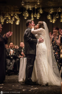 A bride and groom share a heartfelt kiss during their unforgettable New Year's Eve wedding ceremony.