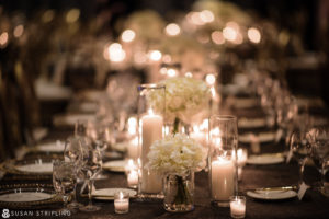 A romantic table set up with candles and flowers, perfect for a new year's eve wedding.