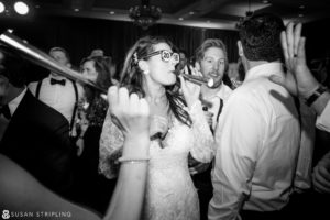 A bride and groom are dancing at a new year's eve wedding reception.