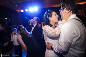 A newlywed couple sharing a dance at their intimate New Year's Eve wedding reception.