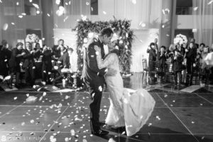 A Cescaphe Philadelphia wedding with a magical moment of a bride and groom sharing a romantic kiss amidst a shower of confetti.