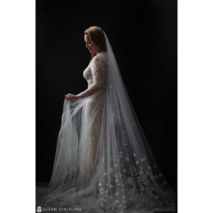 A Canon Explorer of Light bride in a white wedding dress with a long veil.