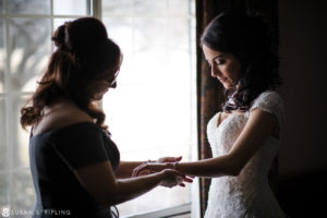 A bride at the Madison Hotel, putting on her wedding ring.