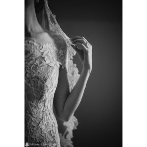 A destination wedding photographer captured a beautiful black and white photo of a bride in a lace wedding dress.