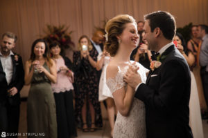 A destination wedding couple sharing their first dance at their reception, captured by a skilled photographer.