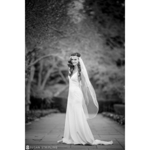 Black and white photo of a bride in a wedding dress at the Brooklyn Botanic Garden during a winter wedding.