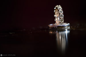 A wedding ring glistening on a reflective surface during a rainy day marriage celebration at Capitale.