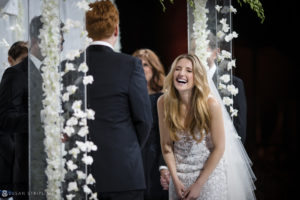 A couple laughing during their rainy day wedding at Capitale.