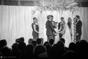 A black and white photo of a rainy day wedding ceremony at Capitale.