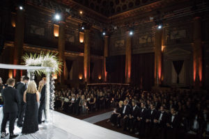 A rainy day wedding at Capitale, held in a large auditorium.