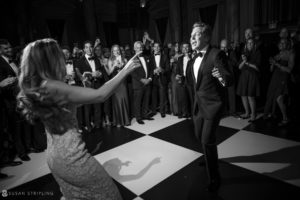 A bride and groom dancing on a rainy day wedding at Capitale, with a checkered floor.
