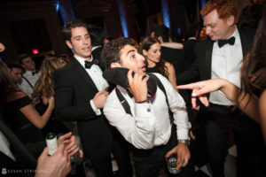 A man wearing a tuxedo at a rainy day wedding at Capitale.