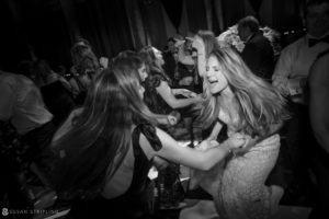 A bride and groom dancing on the dance floor at a rainy day wedding at Capitale.