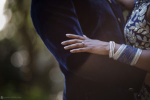 An Indian couple holding each other's hands during their Atlanta wedding.