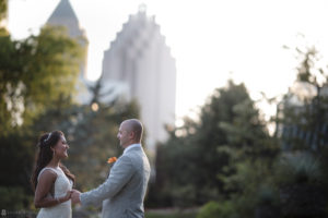 An Indian bride and groom standing in front of the Atlanta city skyline on their wedding day.