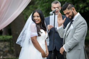 An Indian bride and groom clapping during their wedding ceremony at Tarrytown House Estate.
