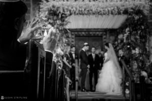 A bride and groom capturing a photo during their summer wedding at Cipriani 42nd Street.