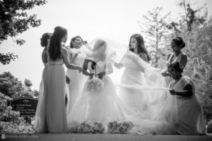 An Indian bride and her bridesmaids are posing for a photo at the Tarrytown House Estate during their wedding.