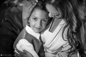 A woman is hugging her son at an Indian wedding at Tarrytown House Estate in black and white.